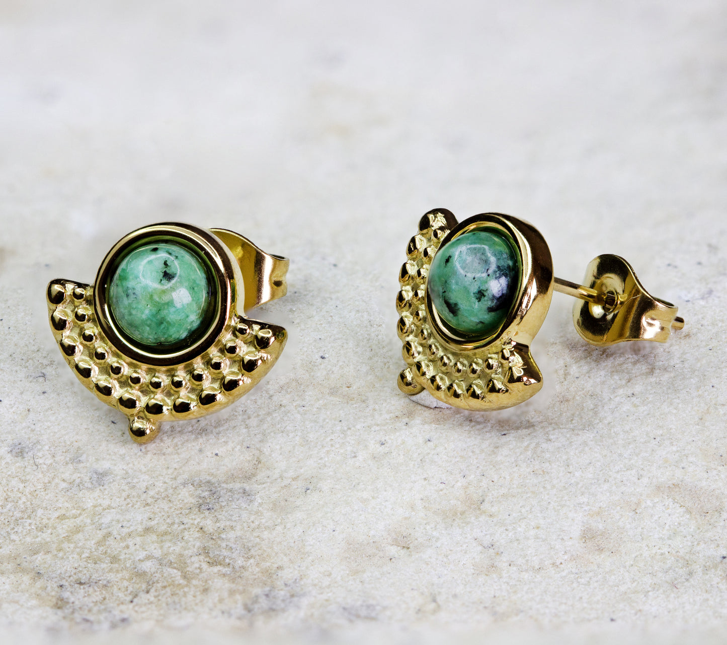 Classic vintage earrings. with a green rund stone set in gold-plated studs. The studs have a 1920s art deco design. The earrings are perfect for a night out at a fancy restaurant. They are available for free delivery within Nairobi. Keywords: jewelry, jewellery.