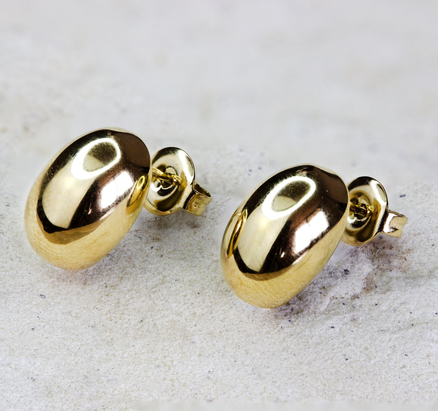 Stunning gold-plated button earrings. Available for free delivery within Nairobi. Keywords: jewelry, jewellery.. The earrings are polished to a mirror finish, catching the light and adding a touch of brilliance to any ensemble. Perfect for combining with a necklace or wearing alone as a statement piece, the earrings are versatile and chic.
