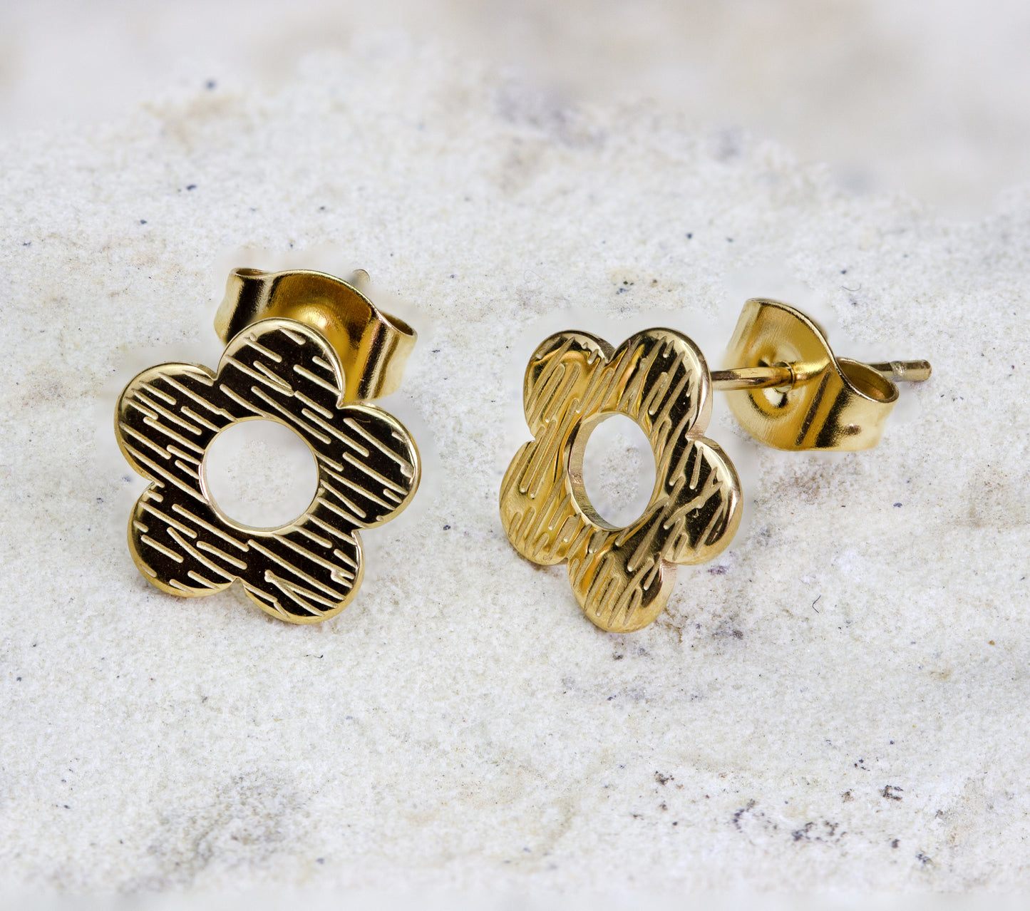 A pair of delicate gold stud earrings in the shape of a simple sring flower. The earrings are cute and ideal fo weekend wear. They are available for free delivery within Nairobi. Keywords: jewelry, jewellery.