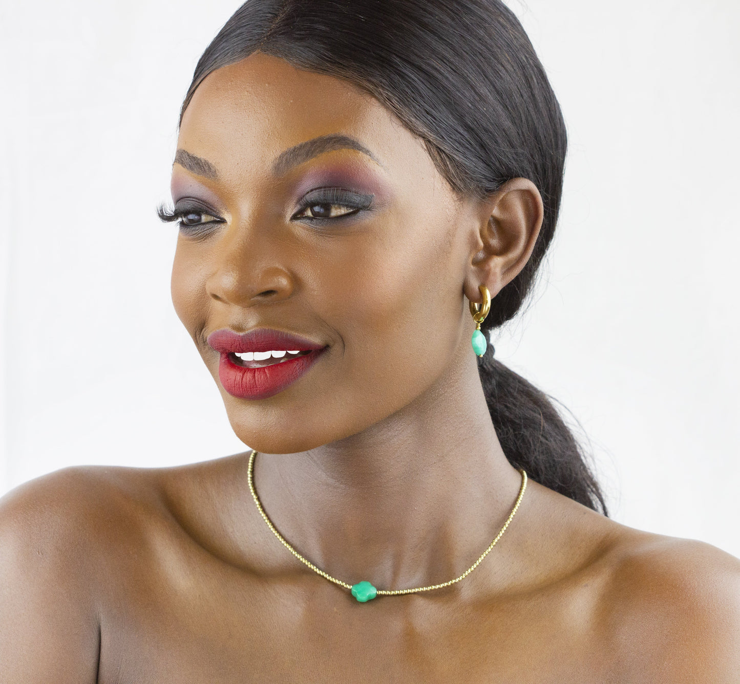 A vibrant smile complements Dahlia Jewels' subtle yet stylish turquoise bead necklace and matching earrings, delivered free in Nairobi.