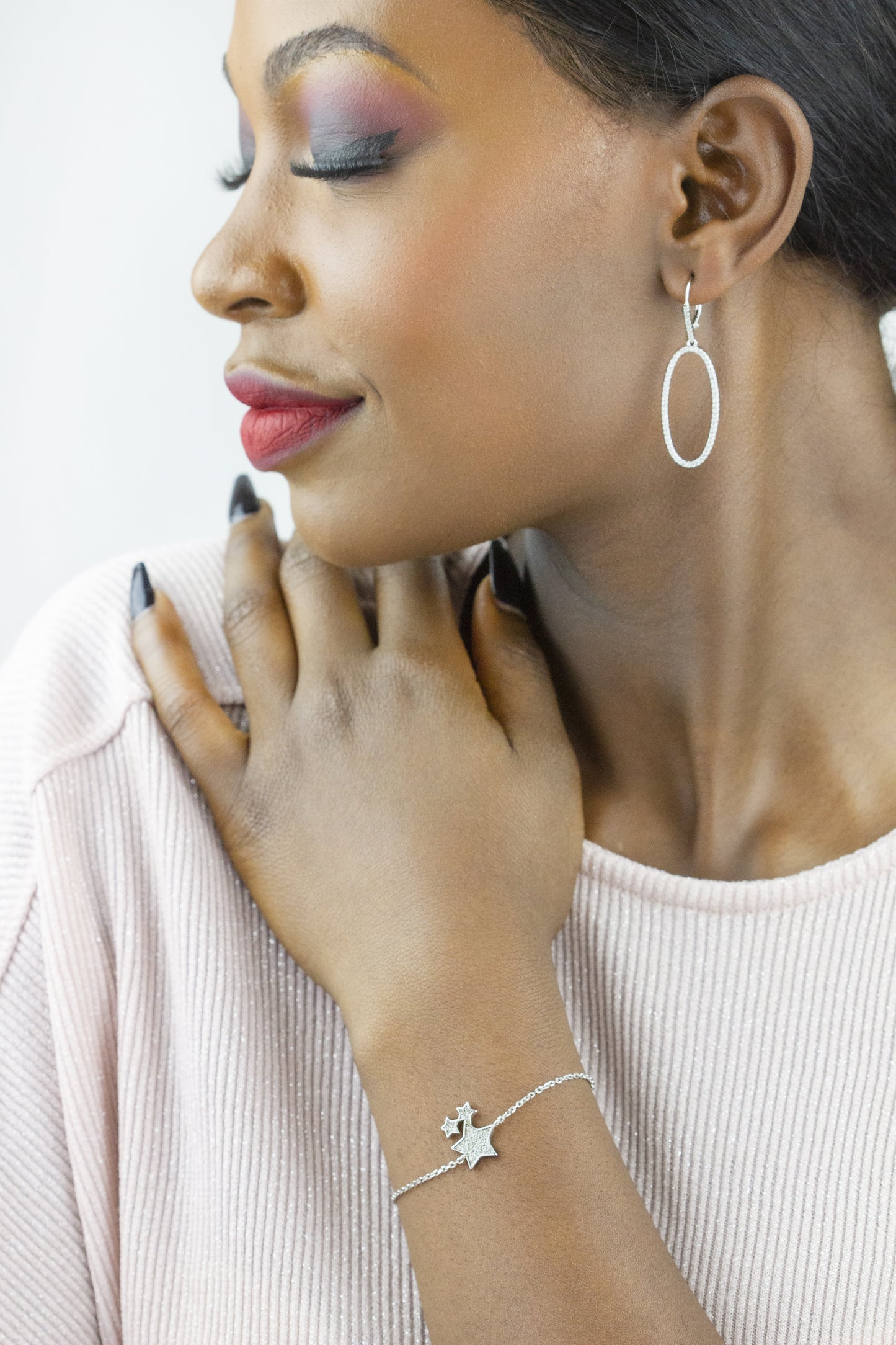 Close-up of Dahlia Jewels gold fan-shaped earrings, reflecting elegant jewelry craftsmanship, offering free delivery in Nairobi.