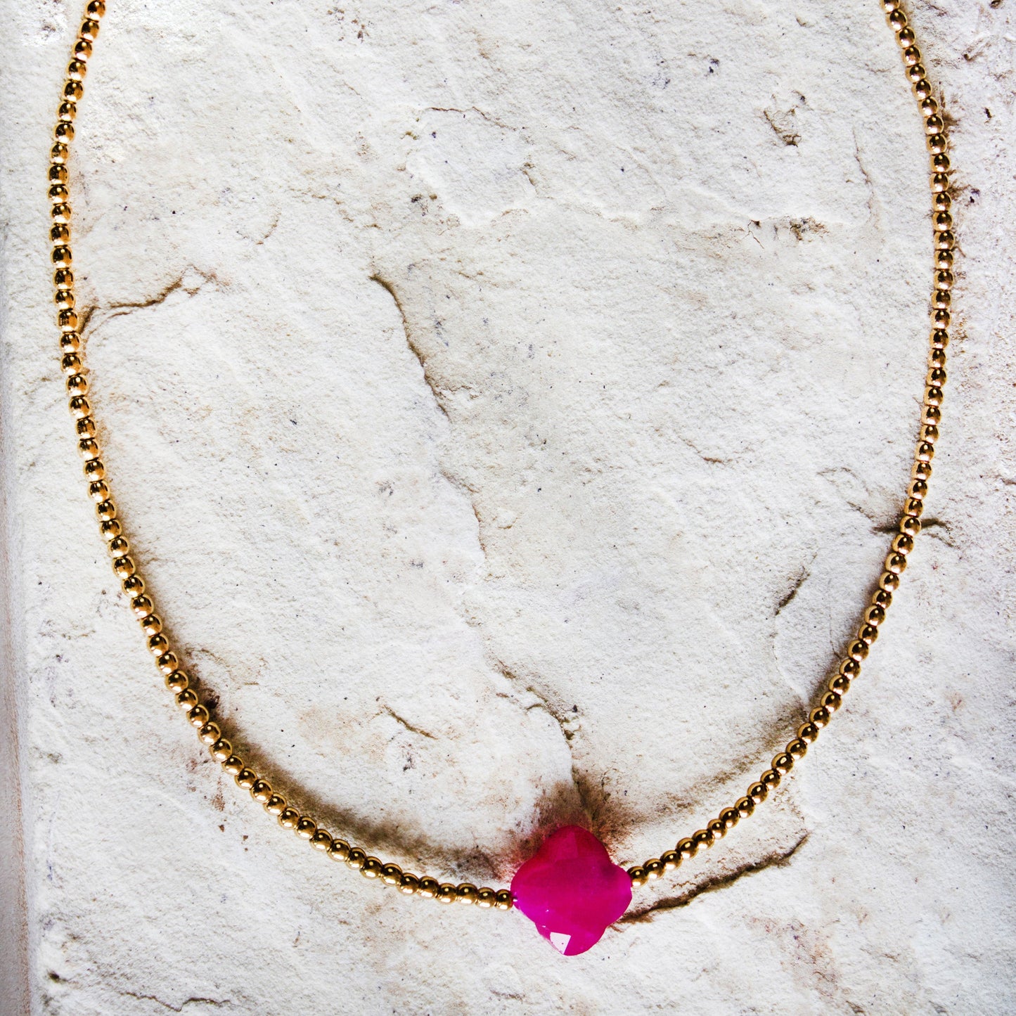 Trendsetting gold-plated necklace with a vibrant magenta stone pendant, a bold jewellery/jewelry statement by Dahlia Jewels, #gorgeouseveryday, Nairobi delivery.