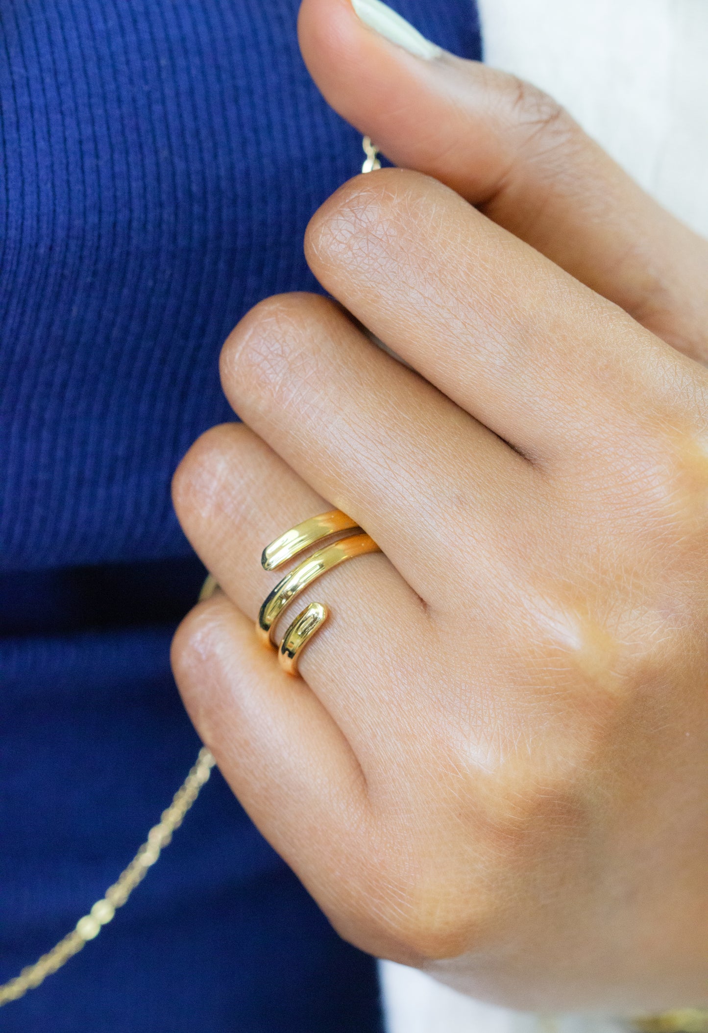 Close-up of a model's hand showcasing a chic gold ring with a sleek design from Dahlia Jewels. Free delivery in Nairobi. Enhance your style with this elegant piece of jewellery.