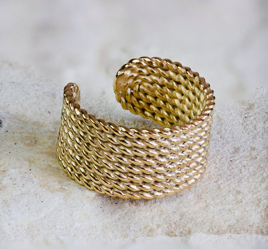 Bold gold ring featuring a textured, woven design with a matte finish. This statement piece adds a touch of elegance and sophistication to any outfit. Available with free delivery in Nairobi. #gorgeouseveryday