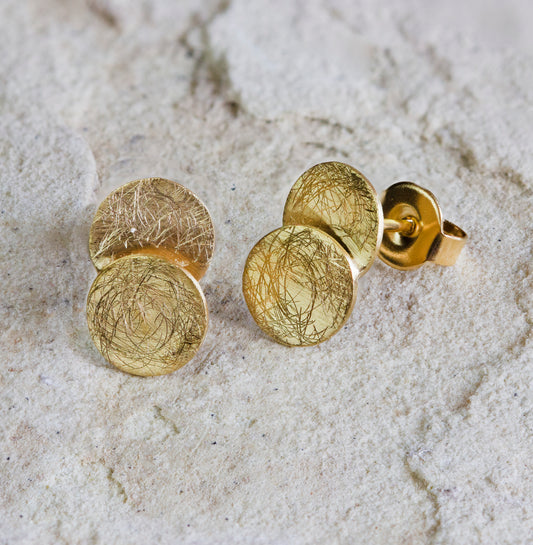 Modern gold stud earrings featuring a trio of textured discs with a scratched, matte finish. These stylish earrings are perfect for adding a subtle touch of elegance to any outfit. Available with free delivery in Nairobi. #gorgeouseveryday