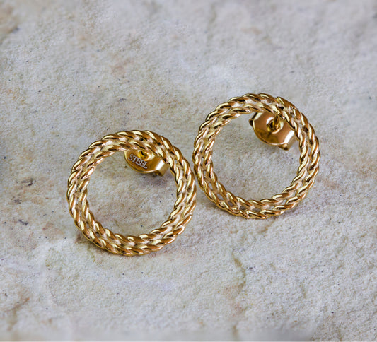 Classic gold stud earrings featuring a twisted rope design in a circular shape. These elegant and timeless earrings add a sophisticated touch to any outfit. Available with free delivery in Nairobi. #gorgeouseveryday