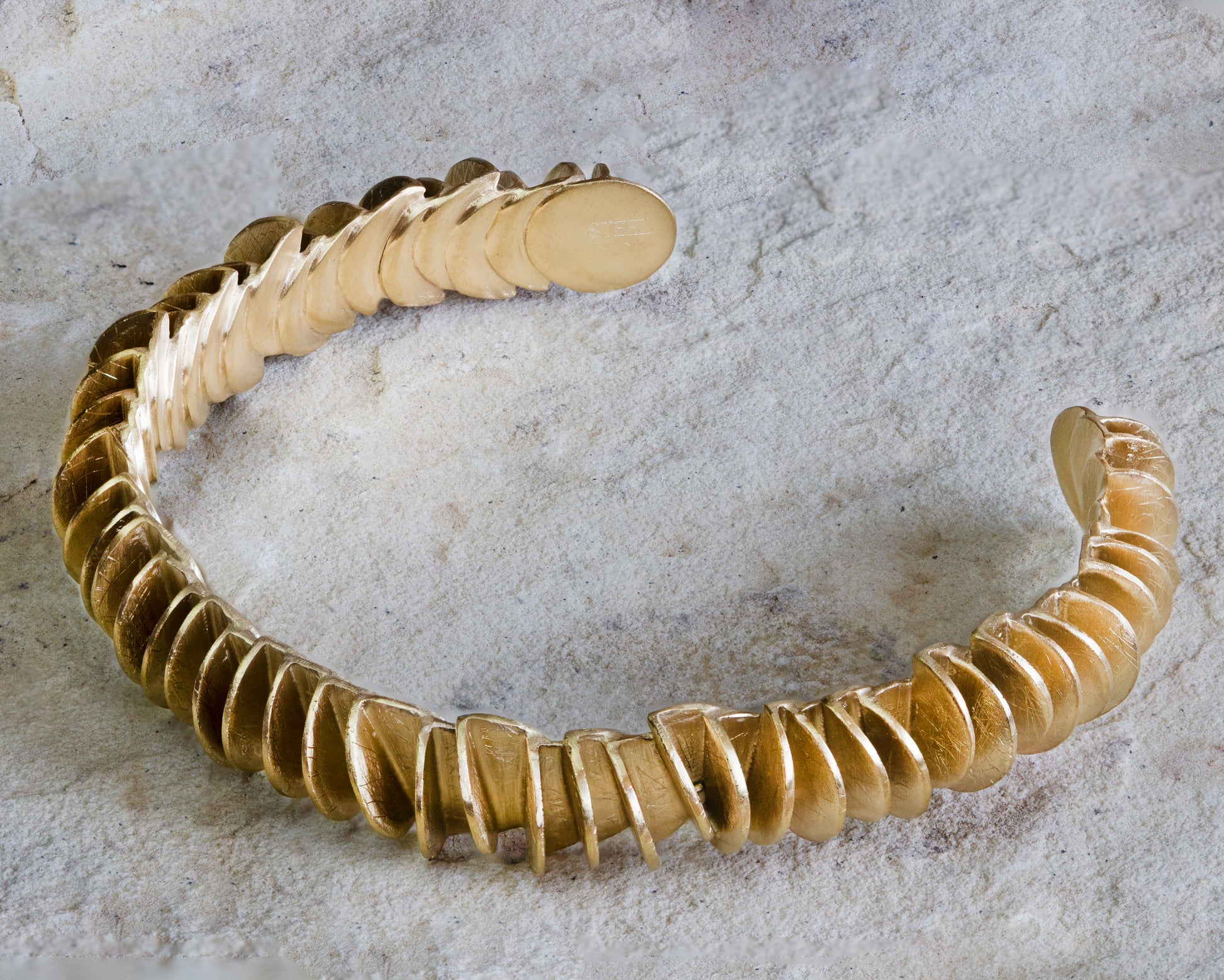 Stunning gold cuff bracelet featuring a unique design of textured, overlapping discs with a matte finish. This statement piece offers a bold and contemporary look, perfect for any occasion. Available with free delivery in Nairobi. #gorgeouseveryday