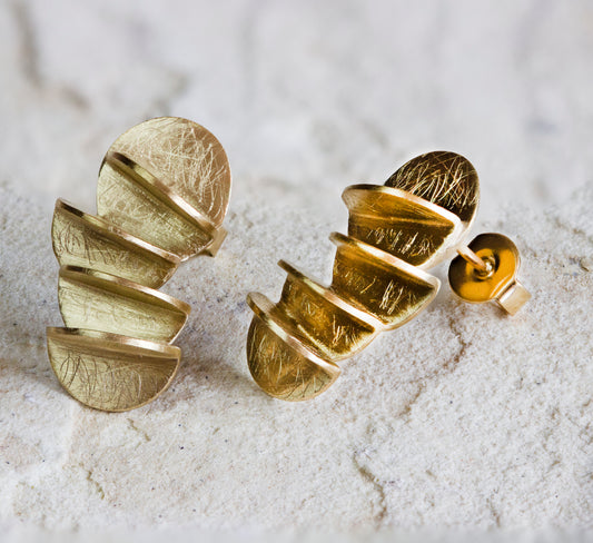 Unique gold stud earrings featuring a bold, segmented design with a textured, scratched finish and modern matte appearance. These eye-catching earrings are perfect for adding a statement look to any outfit. Available with free delivery in Nairobi. #gorgeouseveryday