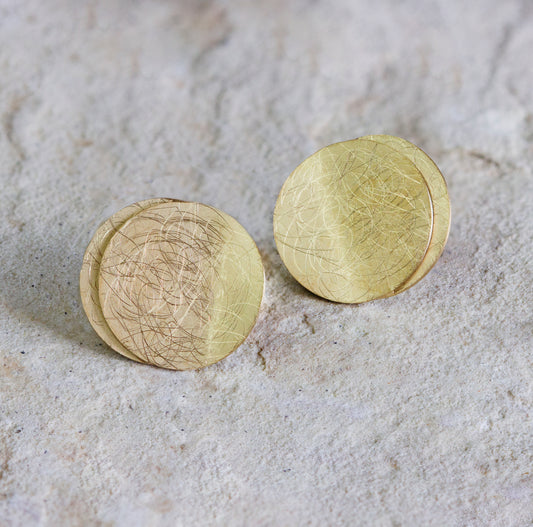 Elegant gold stud earrings featuring layered, textured discs with a subtle scratched design and a matte finish. These contemporary earrings offer a unique and stylish look, perfect for any occasion. Available with free delivery in Nairobi. #gorgeouseveryday