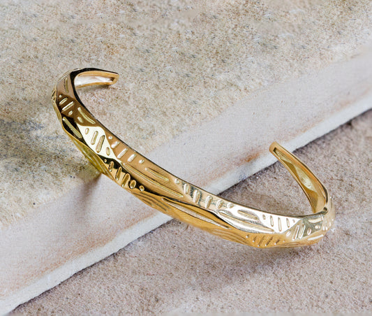 Elegant gold cuff bracelet featuring an intricate engraved pattern and a polished finish. This timeless piece adds a refined touch of sophistication to any outfit. Available with free delivery in Nairobi. #gorgeouseveryday