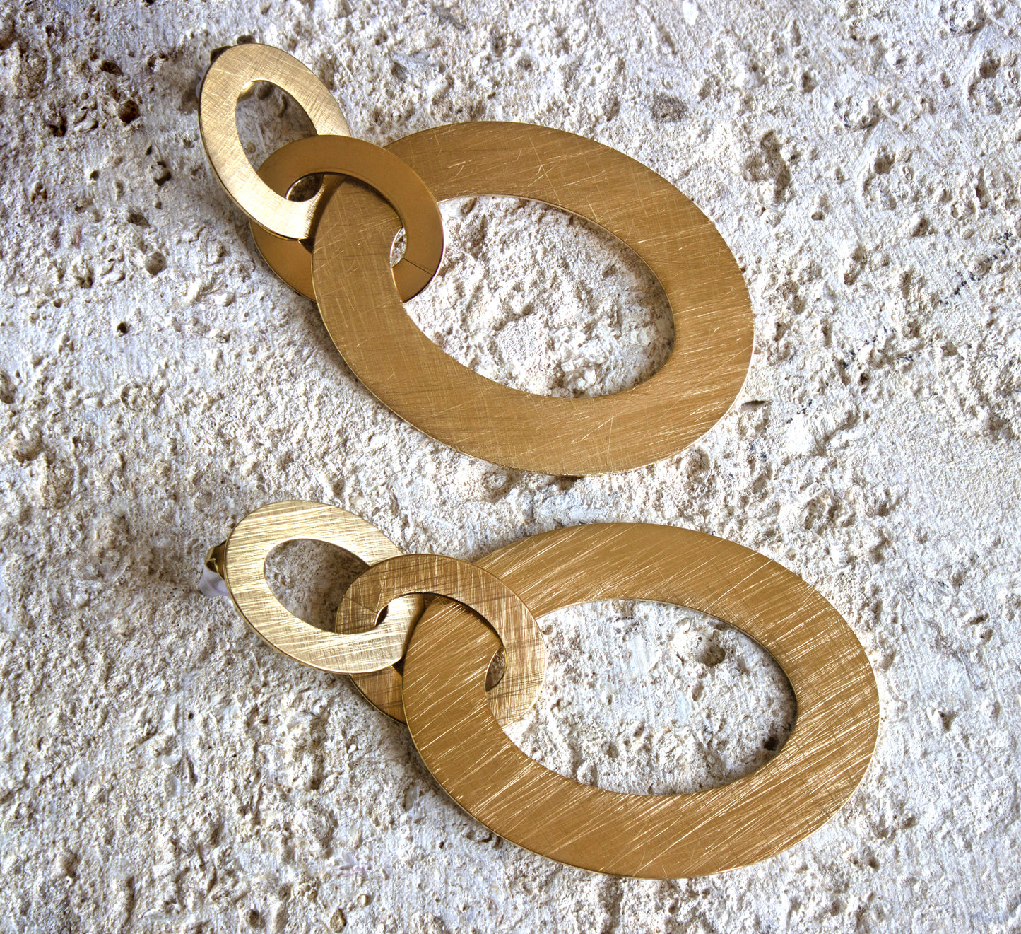 Oversized golden interlocking hoop earrings with a brushed finish, bold and contemporary, for free delivery in Nairobi #gorgeouseveryday