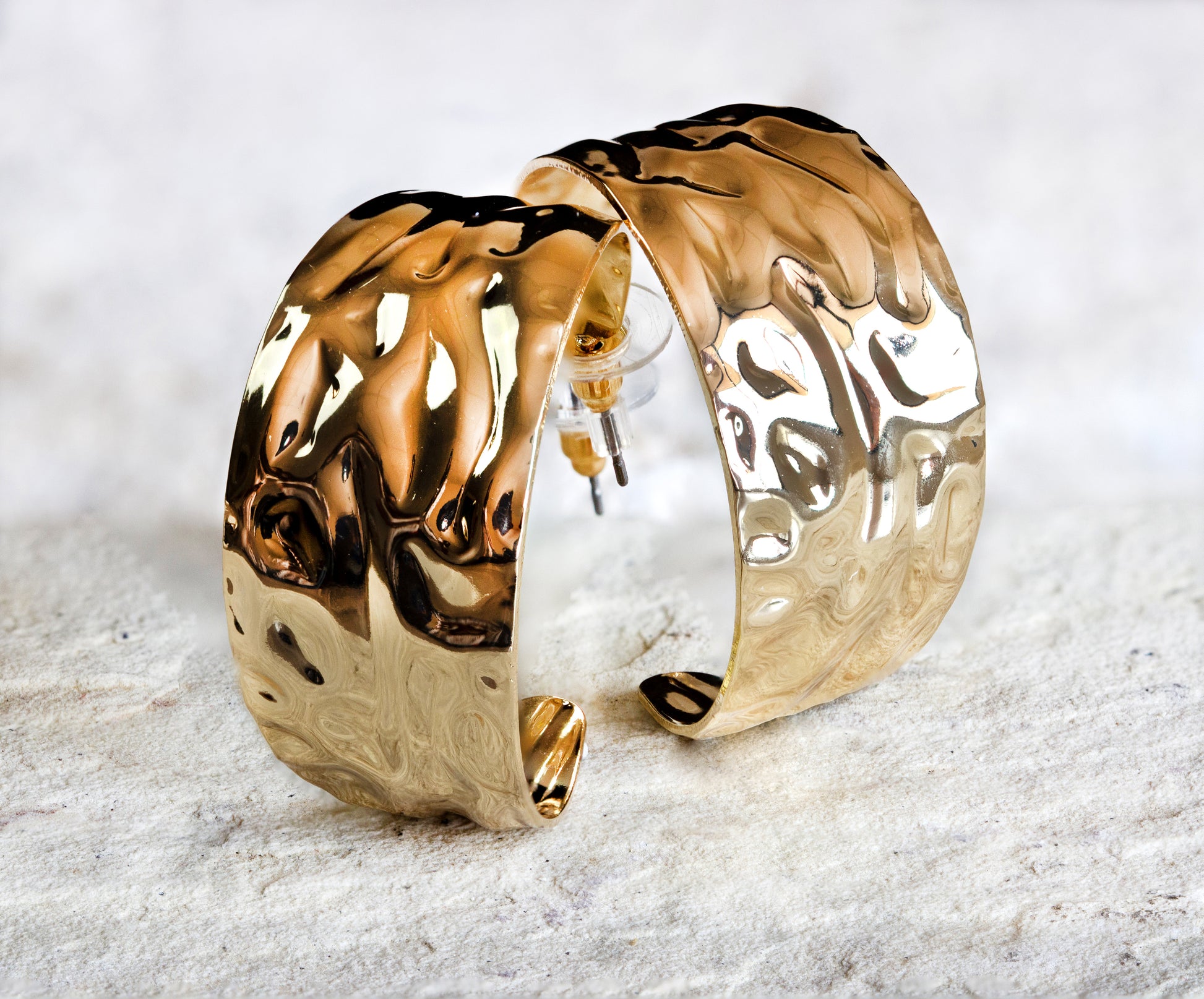 Statement gold hoop earrings with a unique wavy surface, reflecting a contemporary twist on classic design, available in Nairobi #gorgeouseveryday