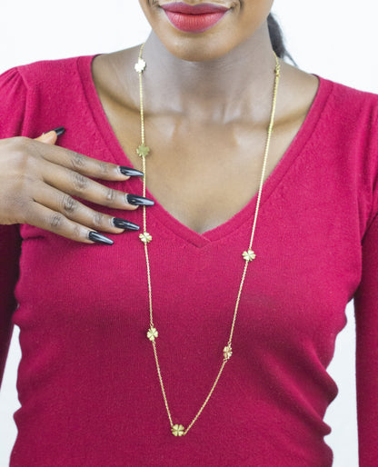 Model's hand delicately holding a Dahlia Jewels' statement necklace, showcasing exquisite craftsmanship. Get yours with free jewellery delivery in Nairobi.