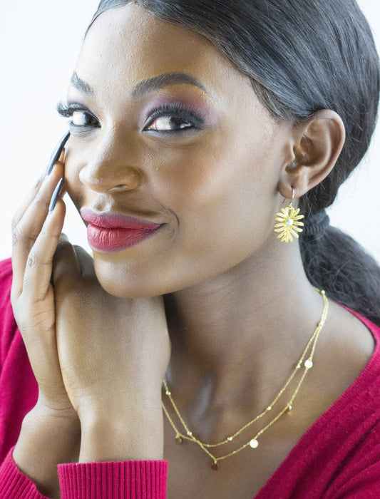 Close-up of Dahlia Jewels gold hoops on a model, paired with a layered necklace, emphasizing jewelry variety, with free delivery in Nairobi.