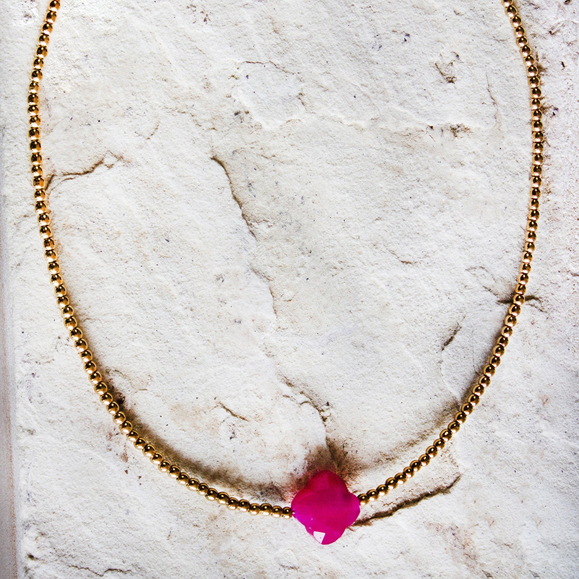 Trendsetting gold-plated necklace with a vibrant magenta stone pendant, a bold jewellery/jewelry statement by Dahlia Jewels, #gorgeouseveryday, Nairobi delivery.