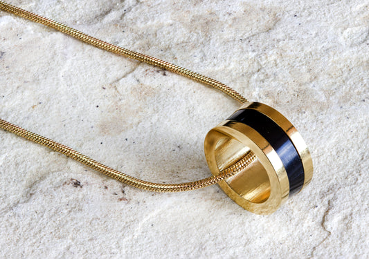 Gold-plated necklace with a sleek black and gold ring pendant, showcasing modern jewelry design, free delivery in Nairobi, #gorgeouseveryday