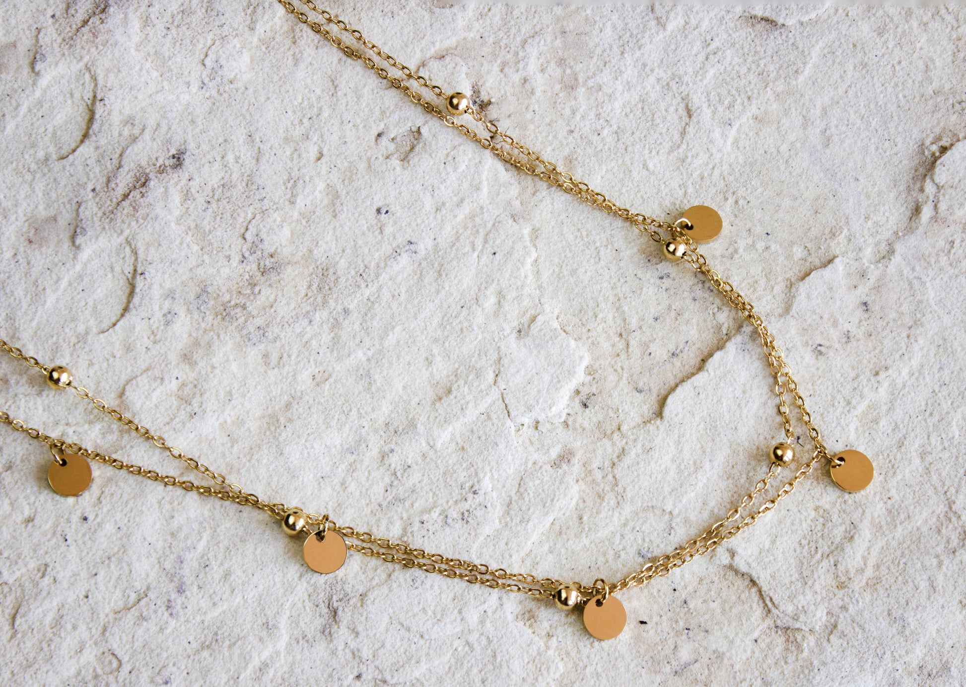 Versatile gold-plated necklace featuring evenly spaced disc pendants, from Dahlia Jewels, perfect for layering or solo wear, with free delivery in Nairobi, #gorgeouseveryday.