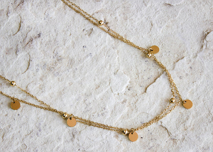 Versatile gold-plated necklace featuring evenly spaced disc pendants, from Dahlia Jewels, perfect for layering or solo wear, with free delivery in Nairobi, #gorgeouseveryday.