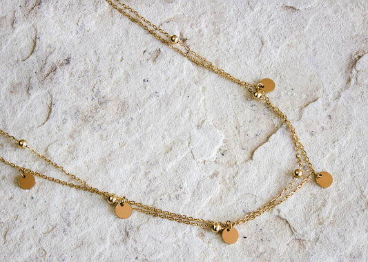 Versatile gold-plated necklace featuring evenly spaced disc pendants, from Dahlia Jewels, perfect for layering or solo wear, with free delivery in Nairobi, #gorgeouseveryday.